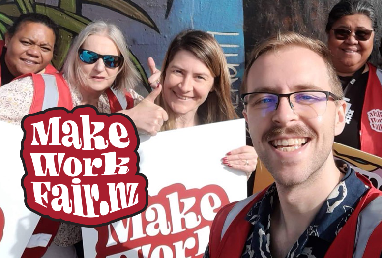 A group of people holding makeworkfair placards