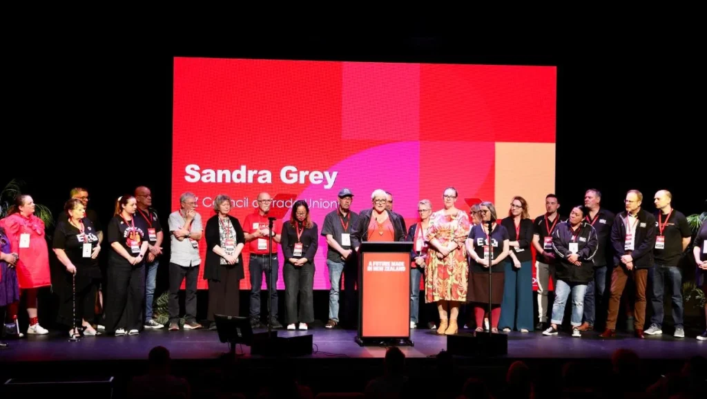 Sandra Grey flanked with union members and representative from affiliated unions. Labour Party Conference 2025. @9 November 2025. Photo credit: NZ Labour Party.