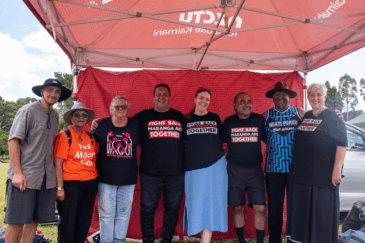 Members of the NZCTU Te Kauae Kaimahi Rūnanga and leadership standing at the CTU tent at Waitangi