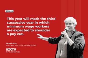 Opinion graphic from NZCTU Te Kauae Kaimahi featuring Sandra Grey, President of NZCTU, speaking into a microphone against a red background. Text reads: "This year will mark the third successive year in which minimum wage workers are expected to shoulder a pay cut."
