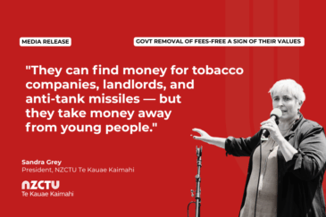 Social media tile with a red background and the NZCTU Te Kauae Kaimahi logo. The headline reads "Govt removal of fees-free a sign of their values". A pull quote from Sandra Grey, President of NZCTU Te Kauae Kaimahi, reads: "They can find money for tobacco companies, landlords, and anti-tank missiles — but they take money away from young people." A black-and-white photo of Sandra Grey speaking into a microphone, gesturing with her hand, sits on the right side of the tile.