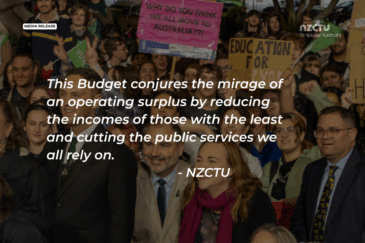 NZCTU Te Kauae Kaimahi media release graphic featuring a quote in white italic text over a photo of a crowded protest: "This Budget conjures the mirage of an operating surplus by reducing the incomes of those with the least and cutting the public services we all rely on. – NZCTU." Protesters hold handmade signs including "Why do you think we all move to Australia??!" and "Education for everyone".