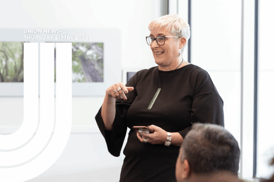 Header graphic for Union News, dated Thursday 21 May 2026. Sandra Grey, with short platinum-blonde hair, glasses, and a pounamu pendant, speaks to a small audience, gesturing with her right hand and holding a phone in her left. One audience member is visible in the foreground. Behind her, framed artworks hang on a white wall. The NZCTU "U" logo appears in white on the left.