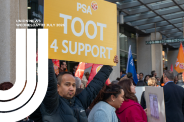 Man at a PSA rally holding a yellow "TOOT 4 SUPPORT" sign above a crowd with union flags outside a Wellington building. Text overlay: "Union News, Wednesday 22 July 2026".