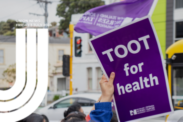 A hand holding up a purple placard reading "Toot for health" with the New Zealand Nurses Organisation logo. A purple NZNO flag flies behind them, with a traffic lights, and a white car in the background. Text overlay reads "Union News, Friday 3 July 2026"