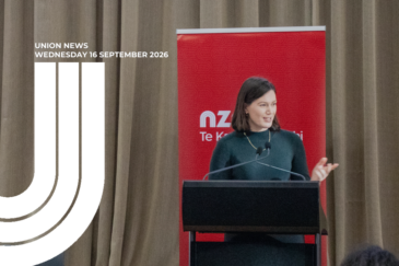 Graphic for Union News: Wednesday 16 September 2026. Colour photo of Brooke van Velden speaking at a black lectern with two microphones, wearing a dark green jumper and a gold necklace. Behind her is a red pull-up banner in front of a beige curtain. White curved lines overlay the left side of the image.