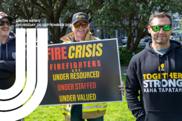 Graphic for Union News: Thursday 24 September 2026. Colour photo of three firefighters standing on grass at Parliament with trees and parked cars behind them. The man in the centre wears an NZPFU cap, sunglasses and high-visibility firefighting trousers, and holds a large sign reading "Fire crisis: firefighters are under resourced, under staffed, under valued". The man on the right wears a black NZPFU hoodie reading "Together stronger – Kaha Tapatahi". White curved lines overlay the left side of the image.