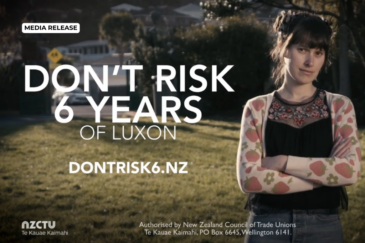 NZCTU campaign photo reading "Don't risk 6 years of Luxon", dontrisk6.nz, with a woman on the right with dark hair standing with her arms folded, wearing a black top and a floral cardigan.