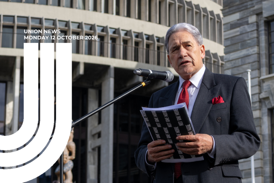 Graphic for Union News: Monday 12 October 2026. Colour photo of Winston Peters speaking at a microphone outside Parliament, wearing a dark suit with a red tie and pocket square. He holds papers and a black folder. The Beehive and Parliament buildings are behind him. White curved lines overlay the left side of the image.