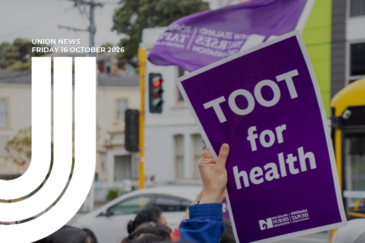 Graphic for Union News: Friday 16 October 2026. Colour photo of a hand holding up a purple placard reading “Toot for health” with the New Zealand Nurses Organisation Tōpūtanga Tapuhi Kaitiaki o Aotearoa logo at the bottom. A purple NZNO flag flies behind it, with a street, traffic lights and a bus in the background. White curved lines overlay the left side of the image.