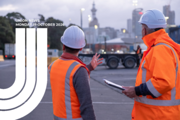 Graphic for Union News: Monday 19 October 2026. Colour photo of two workers in orange high-visibility gear and white hard hats talking at the port, seen from behind. One gestures with his hand while the other holds a clipboard. Trucks, shipping containers and the Auckland skyline are blurred in the background. White curved lines overlay the left side of the image.