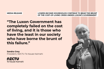 Graphic with a pale peach background for NZCTU media release: Lower-income households continue to bear the brunt of the cost-of-living crisis under Luxon’s Government. Quote: “The Luxon Government has completely failed on the cost of living, and it is those who have the least in our society who have borne the brunt of this failure.” – Sandra Grey, NZCTU President. Black-and-white photo of Sandra Grey speaking into a microphone on a stand, wearing a dark open jacket over a light top.